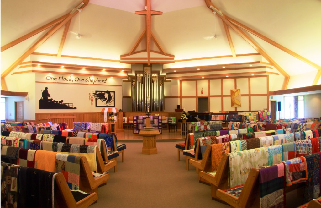 Piecemakers' quilts line the sanctuary pews before being sent on Global Mission